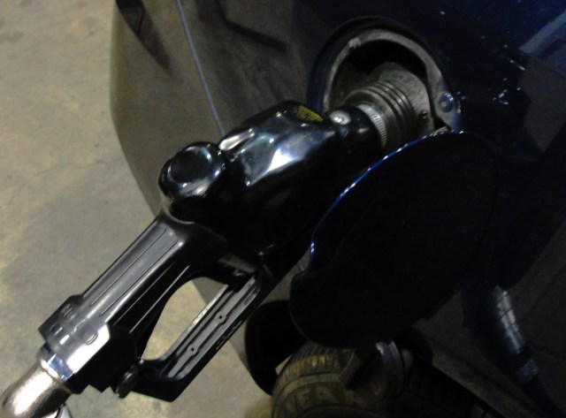 Filling up the car with $4.45 a gallon gas.