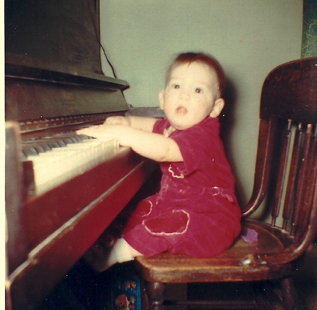 Child playing piano - old upright piano