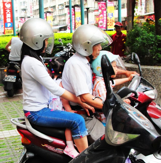 Taipei Family transportation. Four people on one scooter.