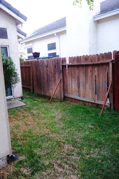 Fence, backyard, leaning fence, propped fence