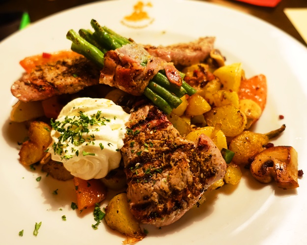 Special platter, pork steak, fried potatoes, bacon, beans